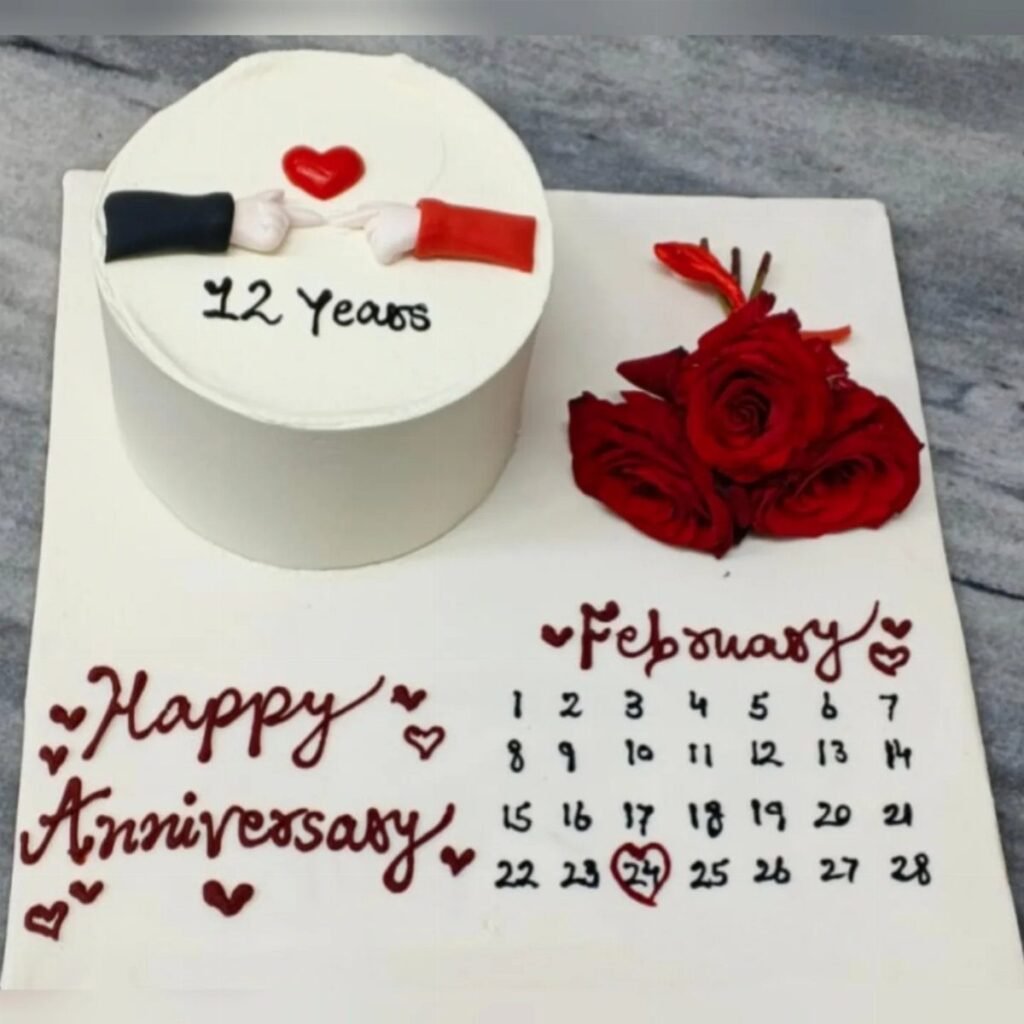 White anniversary cake with 12 years text, red roses, and February calendar board.
