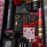 Personalized men's gift box with black accessories, red roses, and a love agreement card.