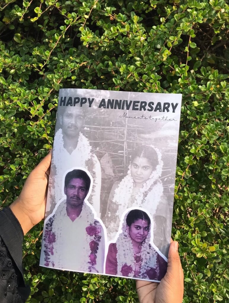 Personalized photo album cover with anniversary photos held against a green hedge background.