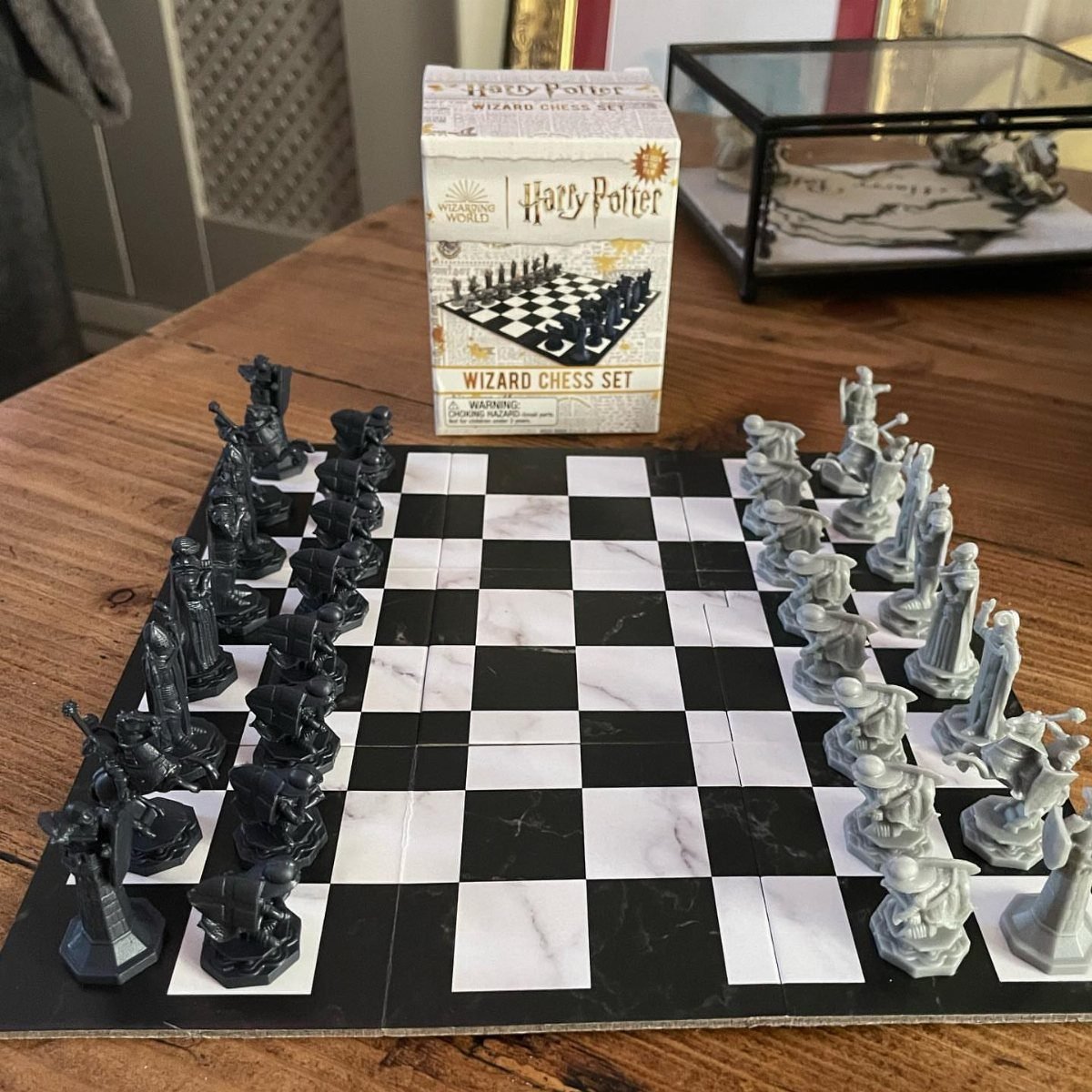 Harry Potter Wizard Chess set with black and white pieces on a marble board