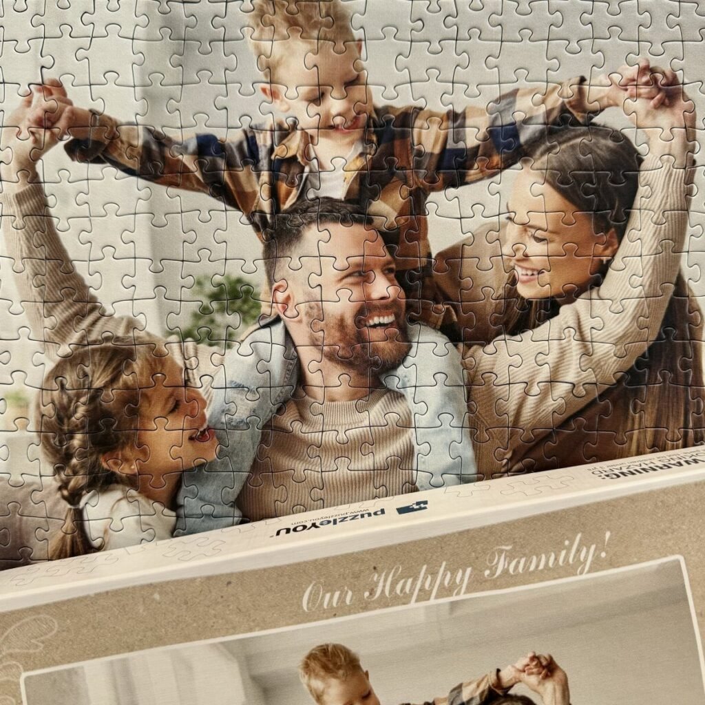 Completed jigsaw puzzle of a happy family resting in its original cardboard box.