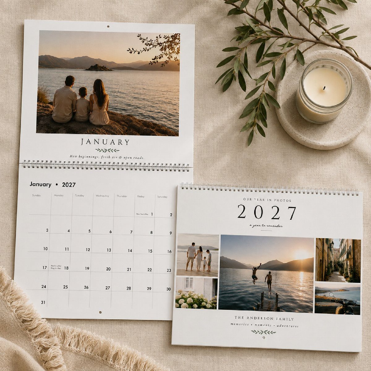 Custom photo calendars with family and travel pictures on a neutral fabric background.